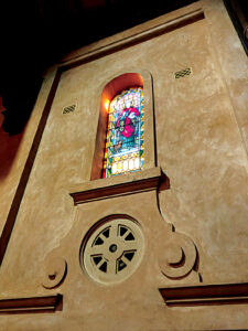 The leadlight window depicting St John the Evangelist. 