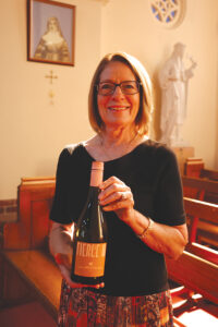 Valerie Miranda with the sacramental wine at Our Lady of the Rosary Church.