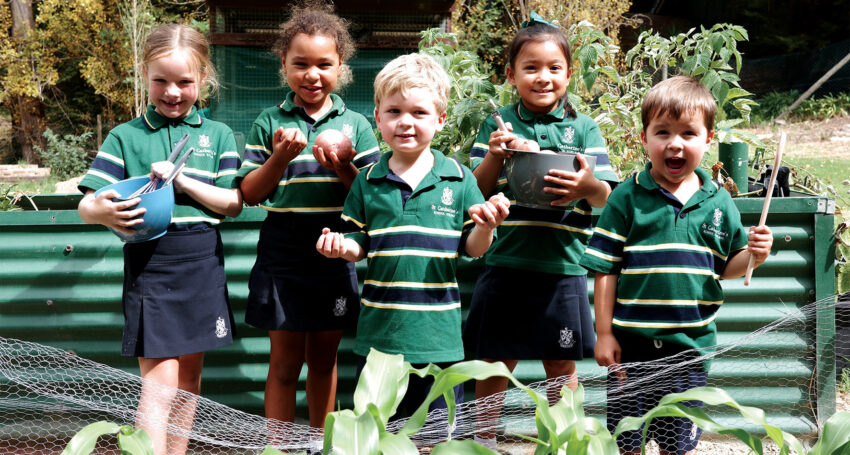 St Catherine's students Maddison, Bridget, Mack, Ariana and Tommy in the veggie garden.