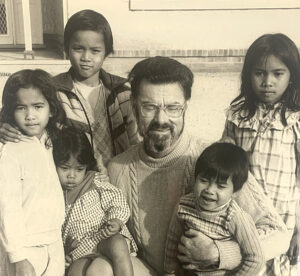 A picture which appeared on the front page of The Southern Cross in May 1984 of Fr Jeff with some children who were supported through the resettlement program. 