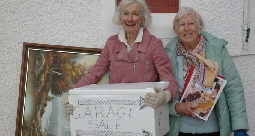 Volunteers Meredith Cunningham and Mary Izzo prepare for the garage sale at St Joan of Arc Church in Victor Harbor.