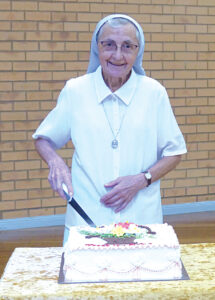 Sr Elda Sbarra cuts a farewell cake.