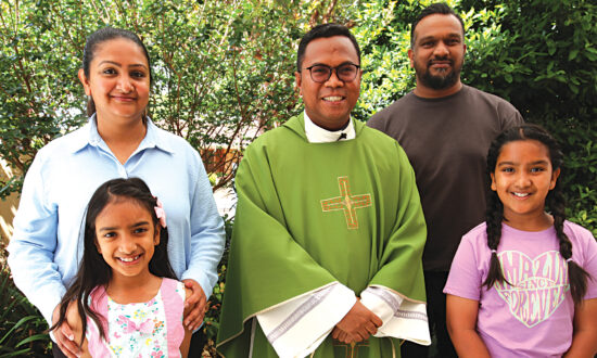 Fr Carlos with the Thiranagama family from Brighton parish, from left – Naomi, Yehali, 8, Fr Carlos, Akhila and Saheli, 11.