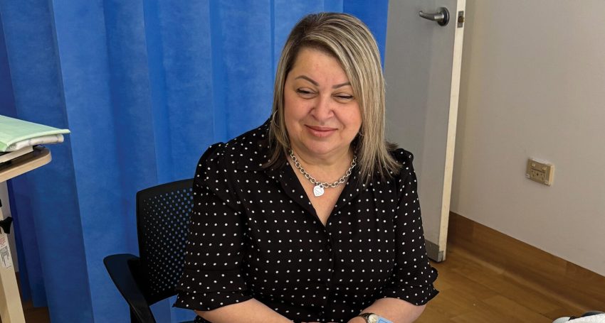 Franca Parente chats with patient David about the prayer of hope on the World Day of the Sick bookmark.